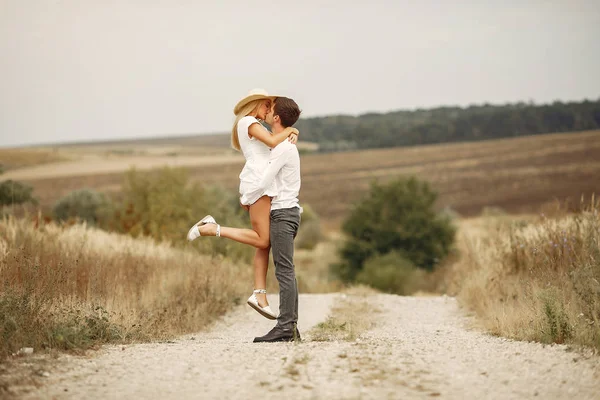 Beautiful couple spend time in a autumn field — Stock Photo, Image