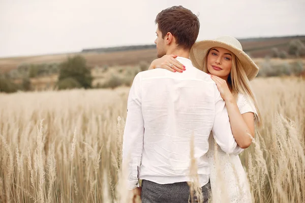 Beautiful couple spend time in a autumn field — Stock Photo, Image