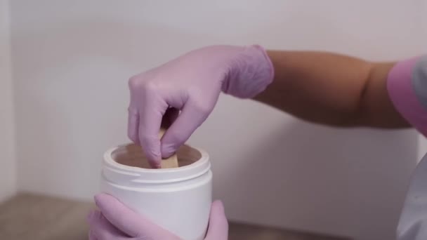 Cropped view of process of taking wax for beautician procedure — Stock Video