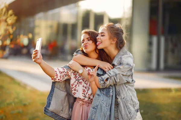 Elegant and stylish girls in a summer park — Stock Photo, Image