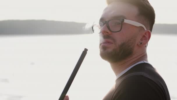 Portrait of bearded man in glasses smoking hookah — Stock Video