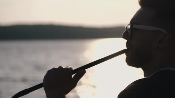 Portrait of bearded man in glasses smoking hookah — Stock Video