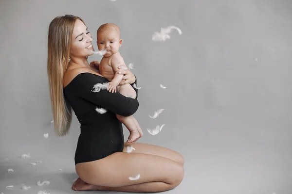 Elegant mother with cute little daughter in a studio — Stock Photo, Image