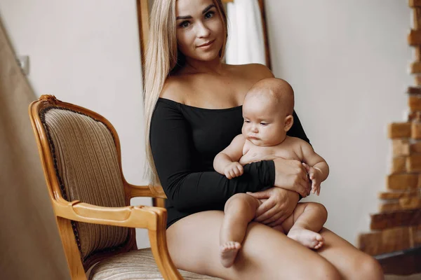 Elegant mother with cute little daughter in a studio — Stock Photo, Image