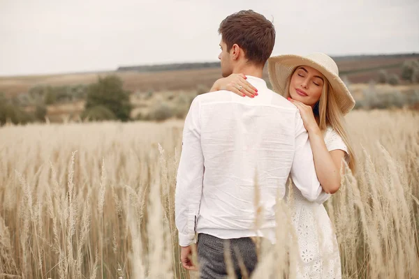 Beautiful couple spend time in a autumn field — Stock Photo, Image