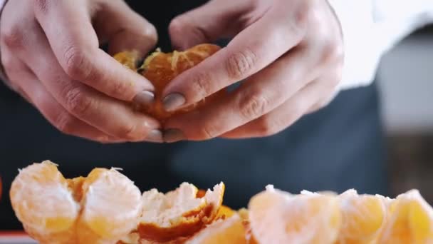 Мандаринський фрукт ділиться на обробну дошку — стокове відео