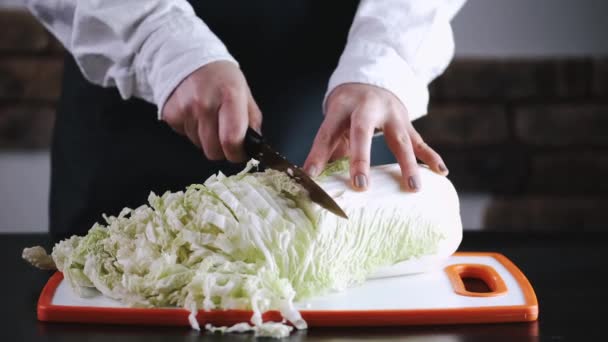 The chef is cutting a cauliflower on a cutting board — Stockvideo