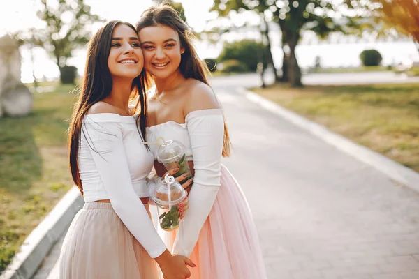 Two pretty girls in a summer park