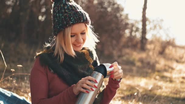 Жінка відкриває колбу і п'є каву з кепки — стокове відео