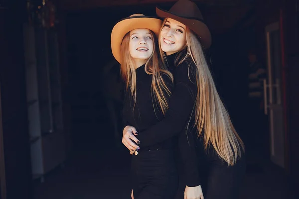 Elegant girls with a horse in a ranch — Stock Photo, Image