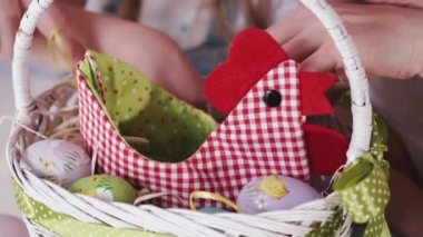 The basket of painted easter eggs is on the table