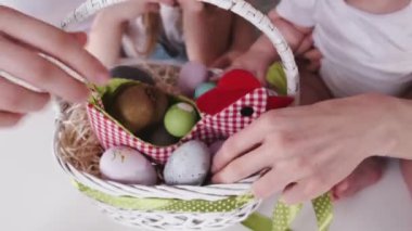 The basket of painted easter eggs is on the table
