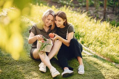 Beautiful family works in a garden near the house