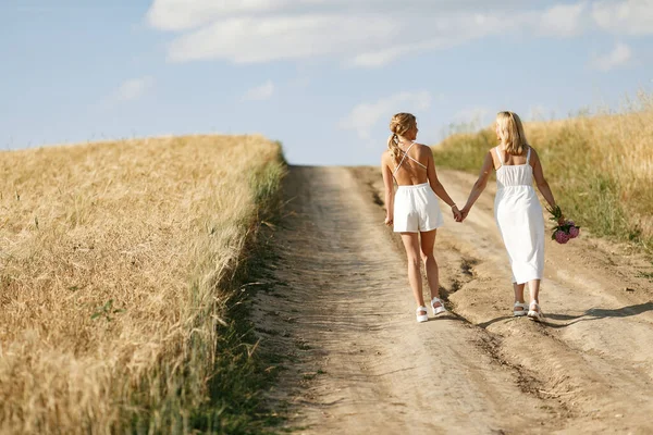 Mother with beautiful daughter in a autumn field — Stock Photo, Image