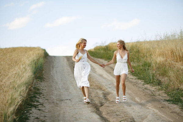 Mother with beautiful daughter in a autumn field