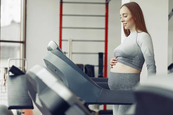 Femeie gravidă de formare într-o sală de gimnastică — Fotografie, imagine de stoc