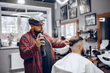 Berber dükkanında oturan şık bir adam.