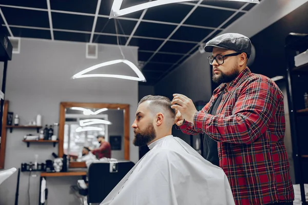 Stilvoller Mann sitzt in einem Friseurladen — Stockfoto