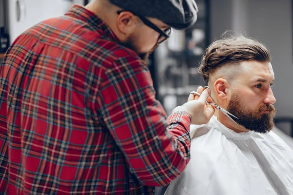 Stilvoller Mann sitzt in einem Friseurladen — Stockfoto