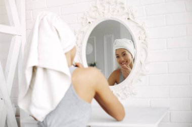 Beautiful girl sitting in a studio with a pomade