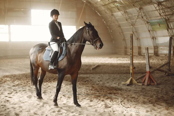 The rider in black form trains with the horse