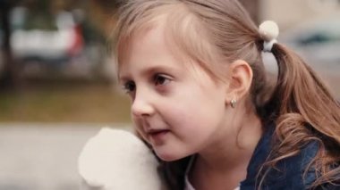 A child is sneezing and a mother is putting a respirator on her face