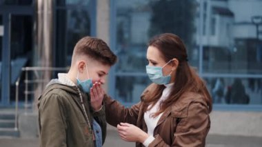 A boy and mother are wearing protective masks