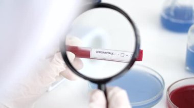 Scientist is examining coronavirus sample in a laboratory