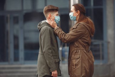 A boy and mother are wearing protective masks