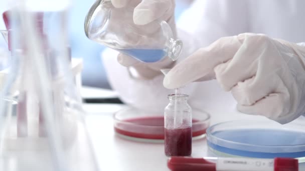 Scientist in coverall suit is making coronavirus test in a lab — Αρχείο Βίντεο