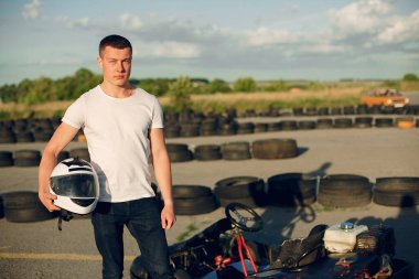Handsome man in a karting with a car