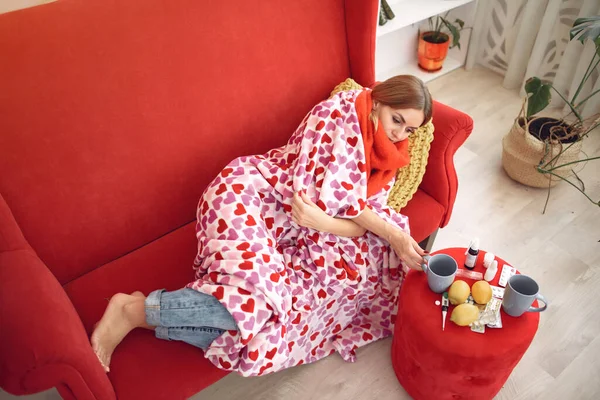 Vrouw zit thuis met een koude en het drinken van warme thee — Stockfoto