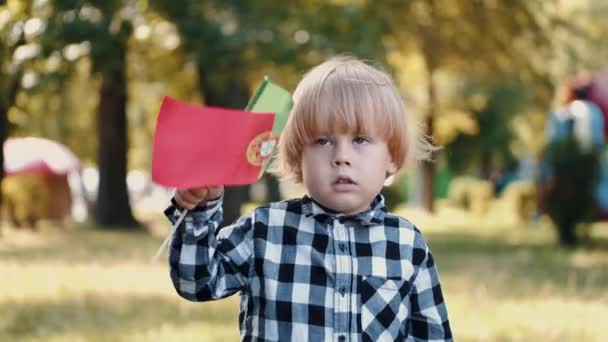 Blond boy in checkered shirt holding Italian flag — Stock Video