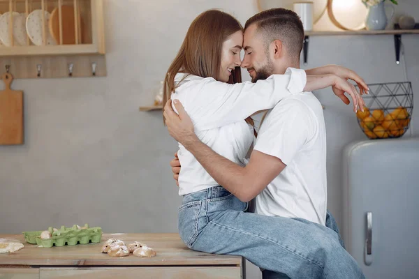 Beautiful couple prepare food in a kitchen — Stock Photo, Image