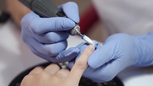 Close-up of beautician hands cleaning female clients nails — Stock Video