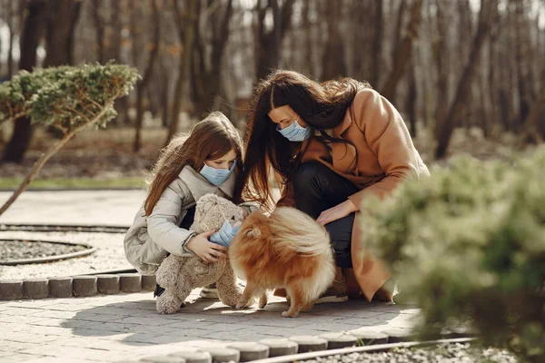 Mother with daughter walks outside in masks