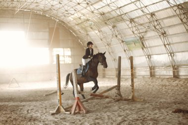 The rider in black form trains with the horse