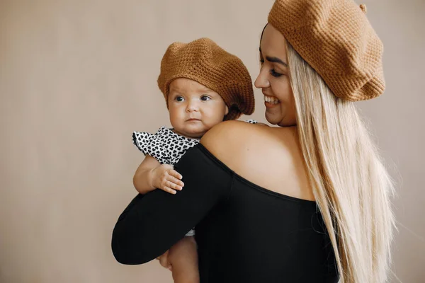 Elegant mother with cute little daughter in a studio — Stock Photo, Image