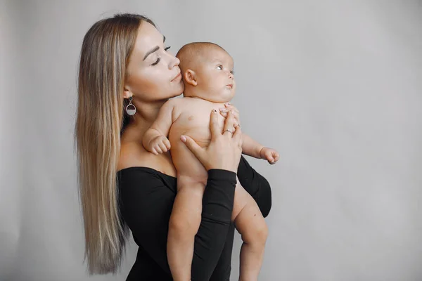 Elegant mother with cute little daughter in a studio — Stock Photo, Image
