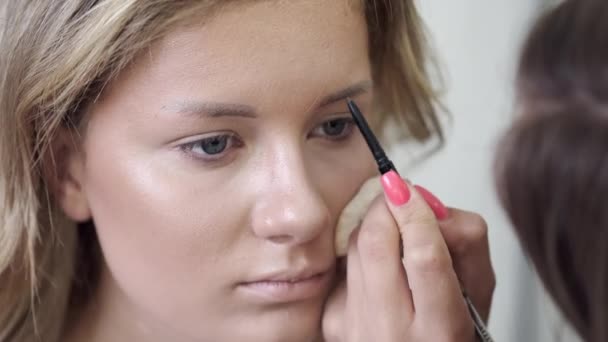 Maquillaje artista dibuja clientes cejas en salón de belleza — Vídeos de Stock