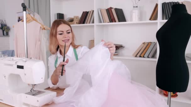 Femme tailleur travaille sur une robe avec ciseaux et machine à coudre — Video