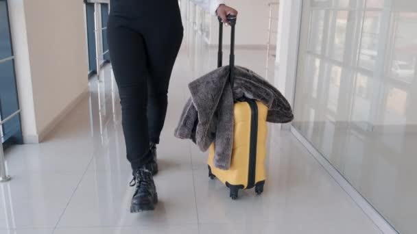 여행 가방을 든 여행자 가 공항 강당을 지나가고 있습니다. — 비디오