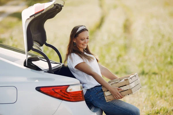 Elegant woman sitting in a trunk with wood box — Stock Photo, Image