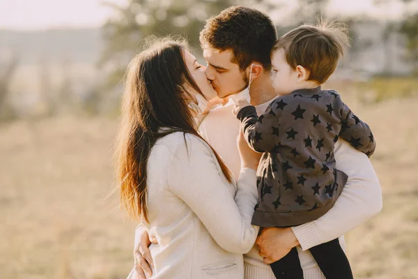 Stylish family in a masks walking on a spring field — Stock Photo, Image