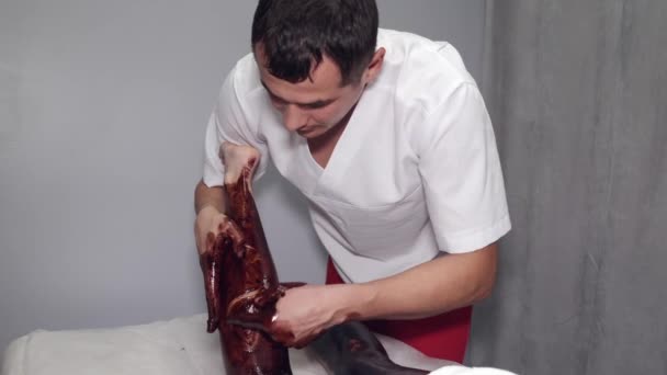 Masérka masírující ženy nohy s hnědou maskou — Stock video