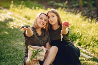 Beautiful family works in a garden near the house