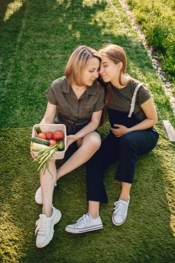 Beautiful family works in a garden near the house