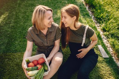 Beautiful family works in a garden near the house