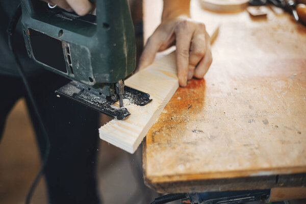 The carpenter works with a tree
