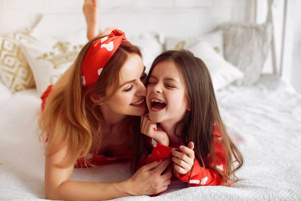 Linda madre e hija en casa en pijama — Foto de Stock